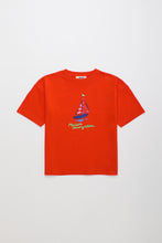 Load image into Gallery viewer, Red t-shirt with a sailboat graphic on a white background
