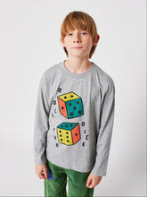 Load image into Gallery viewer, Child wearing a gray long-sleeve shirt with dice design on a white background