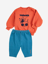 Load image into Gallery viewer, Orange sweatshirt with black graphic and blue pants on a white background