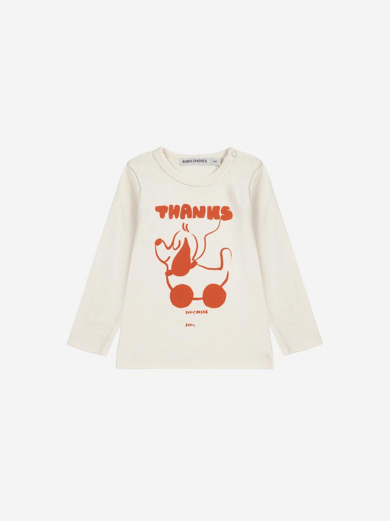 White long-sleeve shirt with red graphic and text on a white background