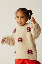 Load image into Gallery viewer, Child wearing a cream sweater with floral patterns on a plain background