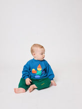 Load image into Gallery viewer, Baby wearing a blue sweater with colorful designs sitting on a white background
